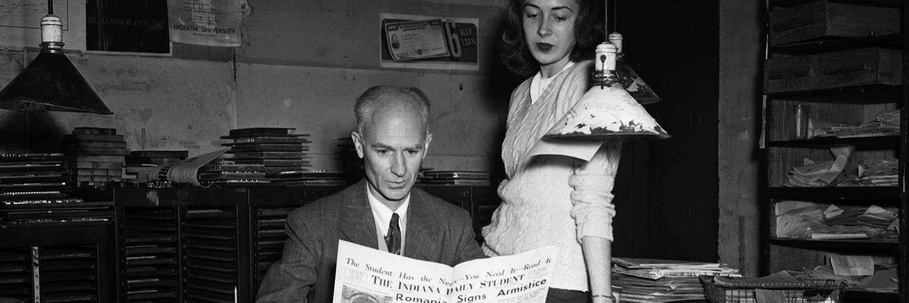 Journalist Ernie Pyle reading a newspaper